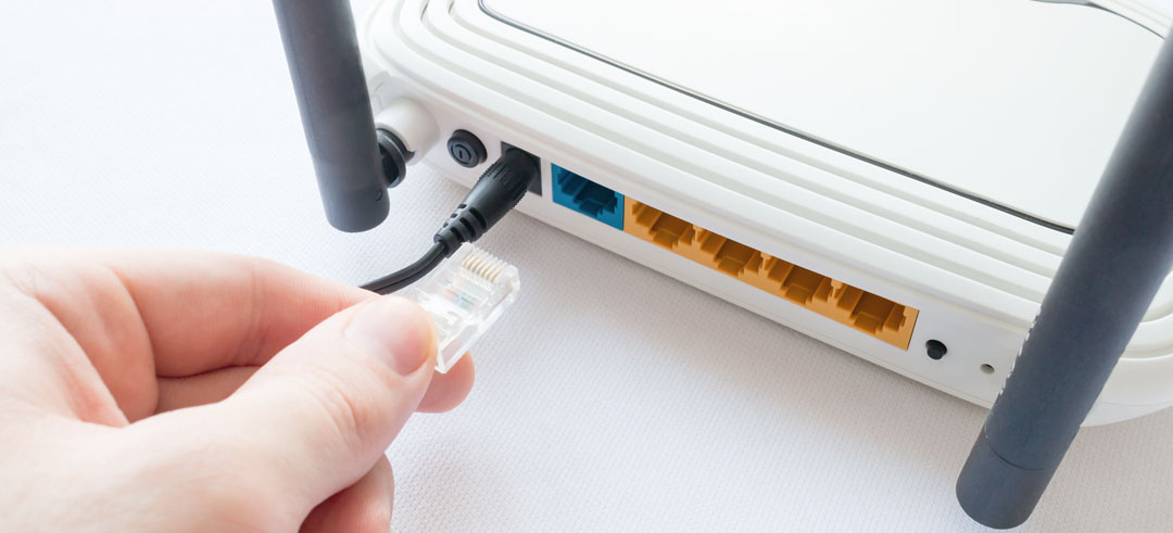 Mano conectando un cable del router